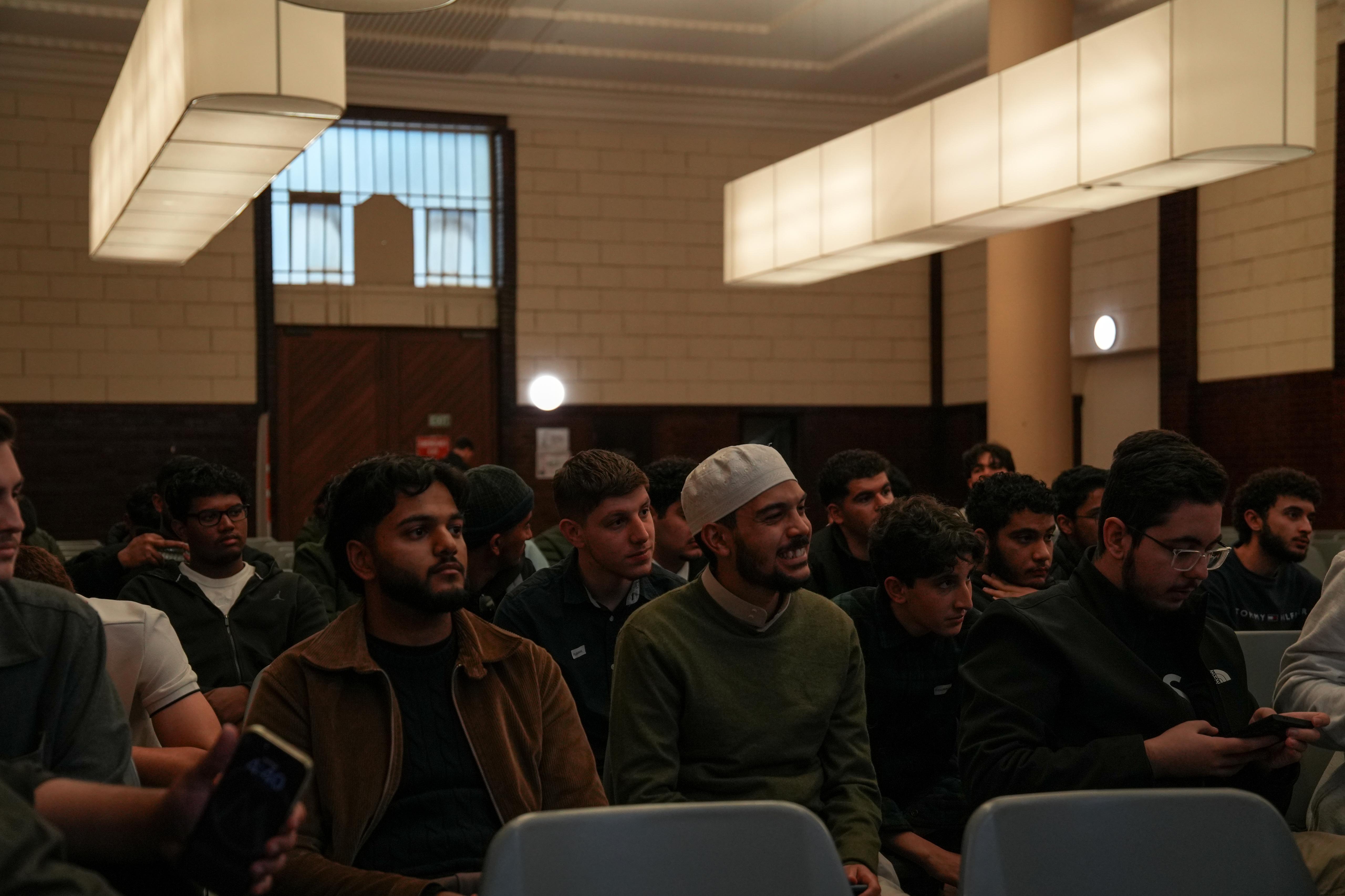 A large audience of young people seated at a UMF community event